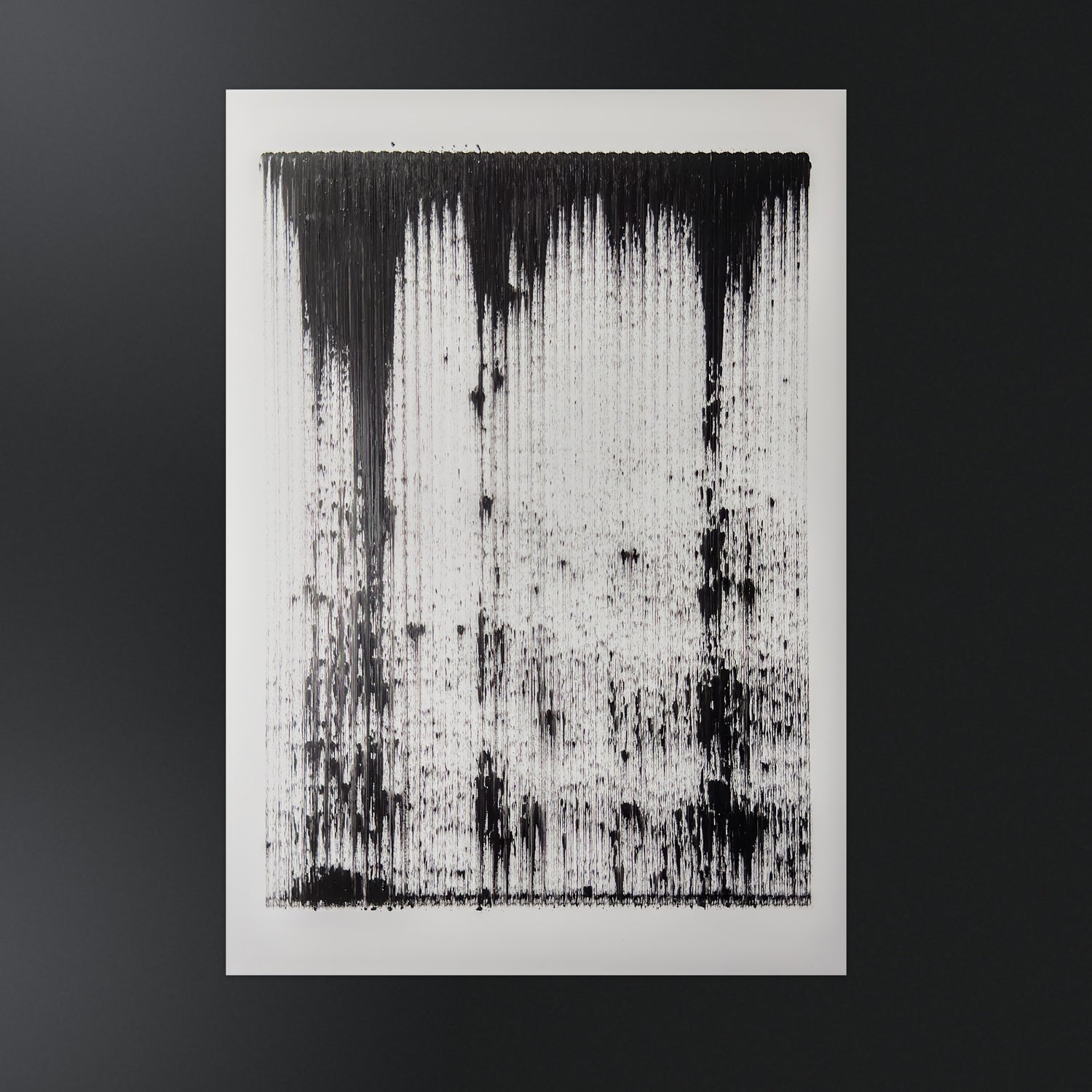 Black abstract painting, acrylic on white Yupo synthetic paper, made with a pen plotter dragging black acrylic paint in repeated and constant vertical gestural strokes. A solid black band runs along the top and rains down in long vertical streaks that grow sparser toward the center, leaving the lower middle mostly open white while heavier clusters gather at the corners and base.